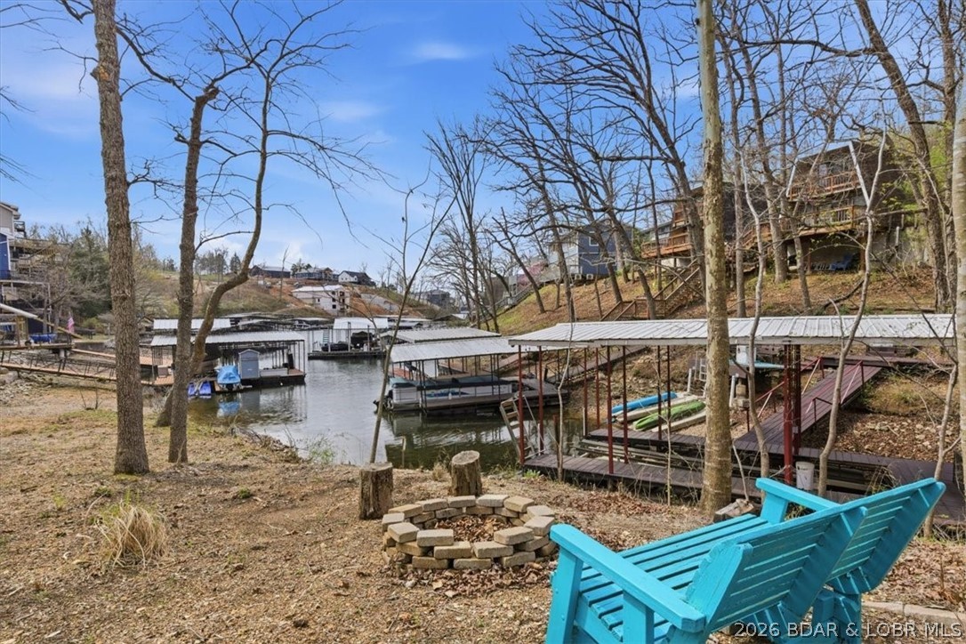 Get ready to entertain and make memories...this beautifully updated lakefront retreat sits on 1.33 acres with an impressive 226 feet of shoreline wrapping around the cove—offering unmatched privacy and a park-like setting. Designed for outdoor living, enjoy multiple entertaining spaces including a spacious deck, patio, and martini deck—all with stunning lake views—plus cozy firepit areas perfect for evenings by the water and even a zipline! This home is completely turn-key with recent updates throughout, making it ideal as a vacation getaway and is already a short-term rental with proven rental income. Plenty of parking and room to expand, add cabins or camping areas or even build another home adds even more potential. The dock features a 10x28 slip with a low water lift for easy docking, along with two PWC drive-on lifts. Conveniently located by land and water at the 5mm of the Osage Arm, you’re just minutes from popular waterfront restaurants, entertainment, and gas docks. This property truly has it all—privacy, views, and lifestyle. Schedule your showing today.
