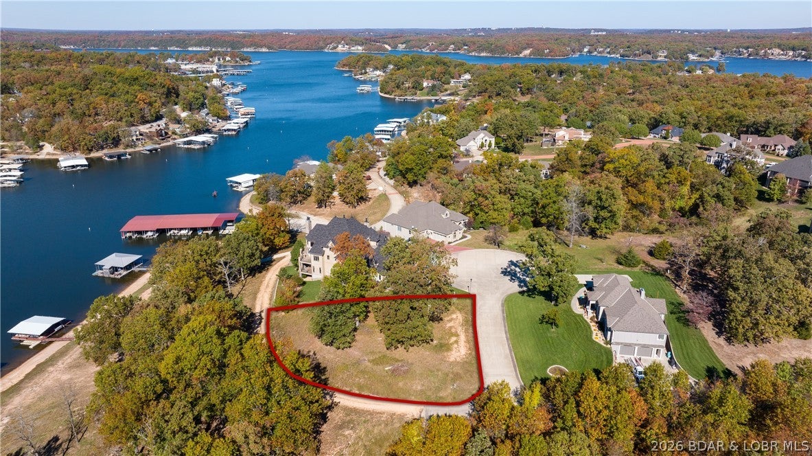 Thinking of building your dream home? Then you need the perfect location to do so! This lakeview corner lot is nestled within a gated community surrounded by pristine homes and offers the added benefit of lake access via the community boat ramp, making it easy to enjoy all that the Lake of the Ozarks has to offer. Located in Osage Beach, you’ll love the close proximity to the hospital, schools, shopping, golf, and much more. Once you enter through the gated entrance, the cobblestone streets will give your new home the entrance it deserves. Be sure to have your house plans ready, as city water, city sewer, and electric are already in place. The gentle topography allows you to build any style of home desired. With beautiful lake views and convenient community boat ramp access, this lot offers the perfect opportunity to build your dream home and enjoy the lake lifestyle.