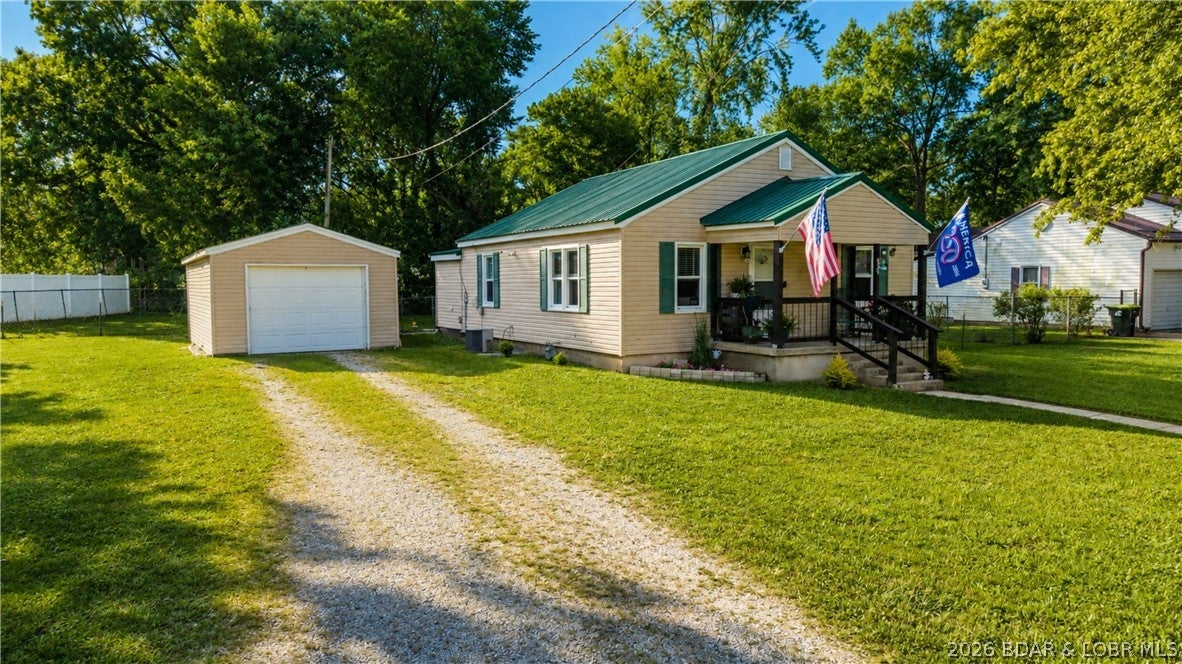 There are a few streets in Versailles that feel like their own little pocket of town, and this is one of them.This 2 bedroom, 1 bath home offers something that can be surprisingly hard to find at this price point: beautiful updates, fresh paint, well maintained & an incredible lot. The kitchen has been thoughtfully remodeled with white cabinetry, warm wood countertops, floating shelves, a large stainless steel sink & plenty of character. Just off the kitchen, the spacious laundry room is one of those everyday spaces you’ll appreciate, with plenty of room to function & convenient access straight to the large backyard. Outside, the oversized fenced backyard gives you room to spread out, whether that means pets, kids, gardening, entertaining or simply having a little more space of your own. A detached garage adds valuable storage or workshop space, while the metal roof on the house offers another peace of mind already in place. Mature trees, a spacious yard & a tucked-away location give the property a setting that feels more private than you’d expect while still keeping you close to everything in Versailles. This is the kind of home that makes everyday living in town more enjoyable.