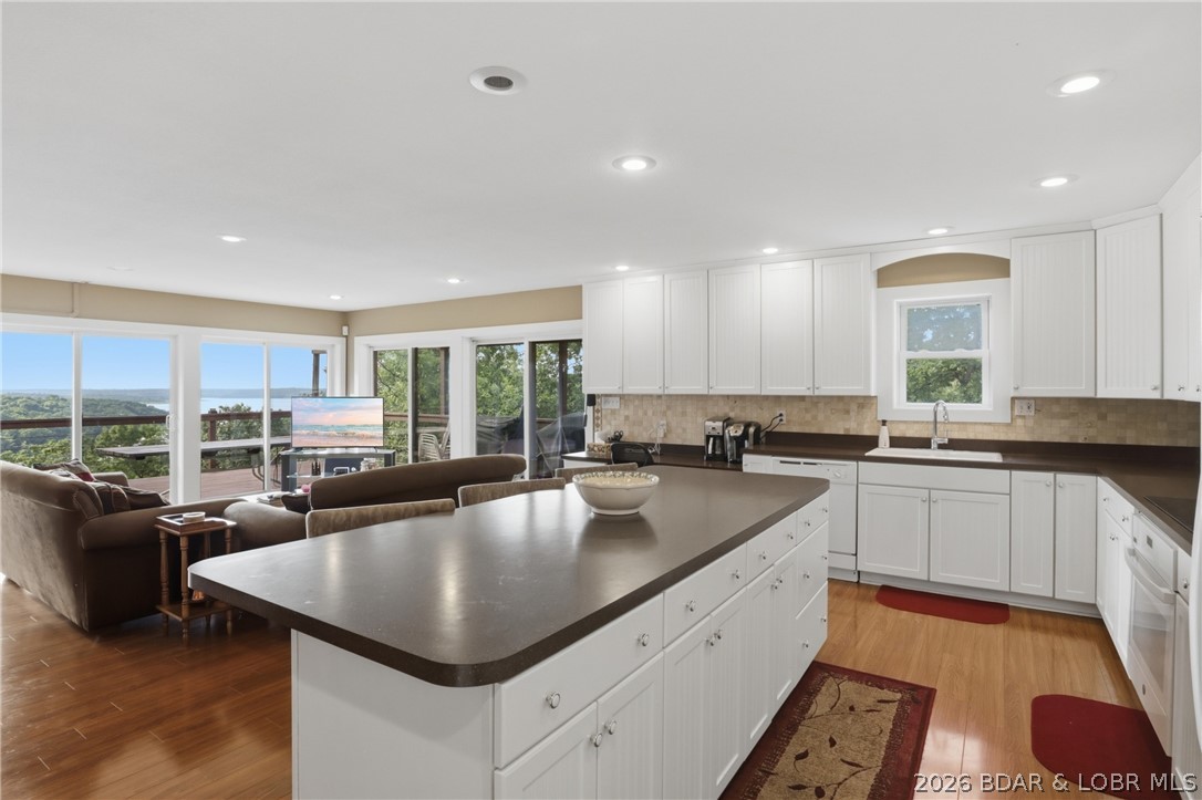 Experience breathtaking year-round views of Truman Lake from this move-in ready home just outside Warsaw, MO. Situated on over 2 acres, this rare property combines panoramic lake views and almost 3,000 SF … a combination that's hard to find. The open-concept living space features expansive windows that fill the living, dining, and kitchen areas with natural light and showcase the lake in every season. 2 main-level bedrooms feature private en-suite bathrooms. The finished walkout lower level offers a second living area, an additional bedroom and a full bathroom, providing flexible space. The wooded lakeside setting and mature trees create a peaceful, secluded atmosphere, while three garage spaces and abundant parking provide room for vehicles, boats, and lake toys. The home is all electric, fully turnkey, and ready for immediate enjoyment. A rented marina boat slip is available to transfer to the new owner if desired, and for those ready to embrace lake life from day one, the current boat lift and boat are also available for purchase separately at closing. Opportunities to own a property offering this level of privacy, acreage, move-in-ready condition, are few and far between.