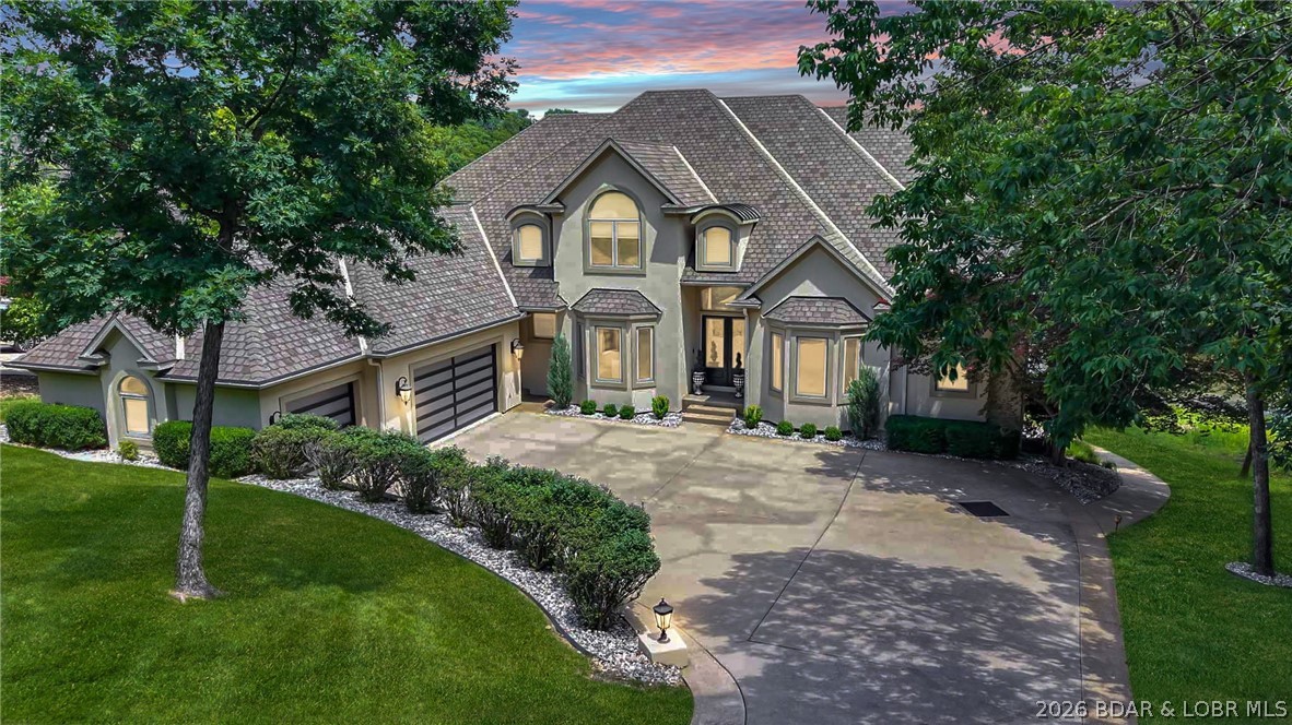 Rarely does a property combine this level of luxury, functionality, & location. Situated in prestigious Porto Cima on a flat half-acre lot w/105 feet of lakefront, this custom 8500+ s.f. estate offers a lifestyle nearly impossible to duplicate at Lake of the Ozarks. The current owners have invested significantly in updates/improvements over the past three years, further elevating an already remarkable property. Designed for effortless living & entertaining, the home features rare zero-step access from the driveway to the home, pool, & dock. Inside, you'll find 7 beds/7 baths, including 5 private suites, professionally curated furnishings, heated floors, & walls of windows showcasing peaceful cove views w/the 13th fairway & green of the Jack Nicklaus Signature Golf Course as a stunning backdrop. The designer kitchen features double ovens, warming drawer, gas cooktop, ice machine, & walk-in pantry. Outside, enjoy a private pool, custom dock w/50-foot slip, morning sun, afternoon shade, 3-car garage, generous parking, & an unbeatable Porto Cima location. Luxury estates offering this combination of size, updates, flat lakefront, golf course views, and dockage rarely become available.
