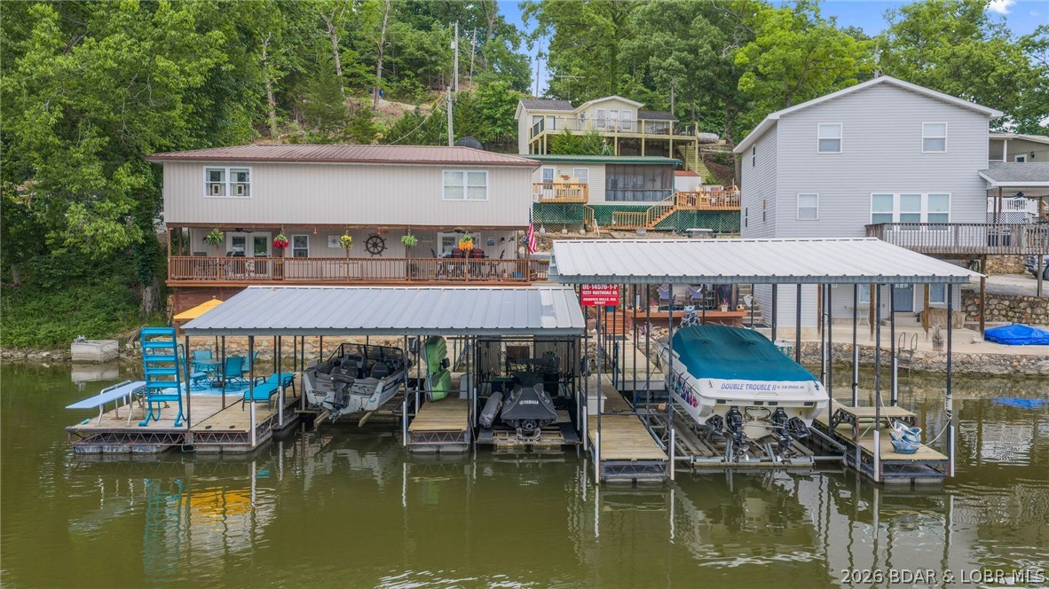 Lake living with room to spread out! Located in a cove-protected setting at the Lake of the Ozarks, this property offers the perfect balance of calm water, lake access, and convenience. Included with the home is a second lakefront lot, giving you additional privacy, extra outdoor space, or future potential. Enjoy peaceful cove living while still being just around the corner from some of the lake’s favorite waterfront bars and restaurants, making it easy to spend your days on the water and your evenings enjoying the best of lake life. Whether you’re looking for a full-time residence, weekend retreat, or investment opportunity, this property offers the kind of location and flexibility that’s hard to find. Quiet water, extra lakefront ground, and close proximity to entertainment—this is Lake of the Ozarks living done right.