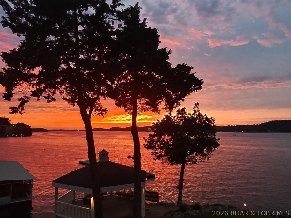 The Point Building #65 at Copper Ridge condominiums has the most incredible views of the lake and sunsets. Fully furnished 2 bedroom and 2 bath condo is perfect for creating cherished lake memories. You'll want to spend your days on the newly refinished screened-in and open decks overlooking the lake. Walk down to the lake's edge to the famous gazebo!  What a great way to spend time watching the boat activity! THE BEAUTIFUL BRAND NEW BOAT DOCKS are amazing- Dock B slip 1 Left side (10'x28') is included and so close, you can see your boat. Newer roofs. Copper Ridge is conveniently close to town, too. Great by water at the 2 mile marker.  Boat down to the Dam or head up to Gravois Arm and cove out on you day off! The Bagnell Dam Stirp, Willmore Lodge, grocery stores, theaters, wonderful state parks are so close to explore. Smaller complex is quiet and cozy, nestled at the end of a small cove- professionally managed and lower assessments. Amenities include well-manicured grounds, lakeside promenade, and community pool. You will love living on the Point - THE VIEW IS SPECTACULAR!!!