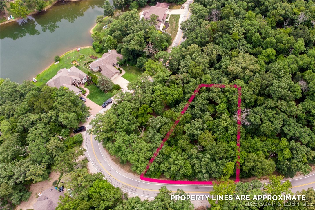 Immerse yourself in the beauty of the Lake of the Ozarks with this exceptional gentle interior lake lot.
Positioned in a prime location, this lot offers a unique opportunity to build your ideal lakeside retreat.
Surrounded by the area's natural splendor and captivating water views, you can create a haven that perfectly
complements your lifestyle. Whether you envision a cozy cabin or a contemporary masterpiece, this property
provides the canvas for your vision to come to life. Enjoy the convenience of nearby amenities and recreational
activities. Don't miss out on claiming your own piece of paradise at the Lake of the Ozarks.