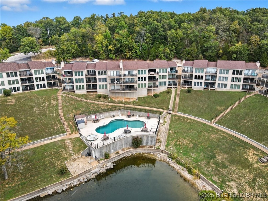 BACK ON THE MARKET!! NO FAULT OF SELLERS, BUYERS LENDING FELL THRU!! Step into your dream home with this beautifully furnished 2-bedroom, 2-bath condo, where comfort meets elegance. Featuring large windows that flood the space with natural light, you’ll enjoy breathtaking lake views from your private deck. Dive into relaxation with two heated pools and two rejuvenating hot tubs, ideal for soaking after a day on the lake. The beautifully landscaped grounds invite you to stroll and enjoy the natural beauty around you, while the proximity to water activities adds an exciting twist to your lifestyle. With a 10 x 20 boat slip w/lift and a personal watercraft (PWC) slip included, water enthusiasts will appreciate the convenience of direct access to the lake. Spend your weekends cruising the waters, fishing, or simply soaking up the sun on your boat—your adventures await just steps from your door! Whether you're looking for a permanent residence, a vacation home, or an investment property, this beautiful condo offers the best of both worlds. Don't miss your chance to own a piece of paradise—schedule your private tour today and experience the magic of lakefront living for yourself!