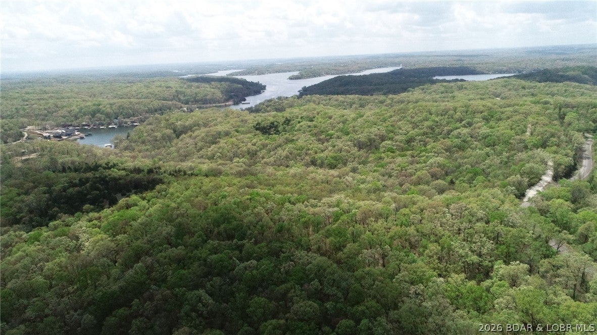 Discover the perfect blend of natural beauty and opportunity with this stunning 5.65-acre parcel nestled in the heart of the Ozarks. Featuring a picturesque landscape of mature trees and gently rolling hills, this property offers an ideal setting for your dream home, weekend retreat, or future investment. With direct access from a paved road, convenience meets tranquility in a location that’s both accessible and serene. Additional acreage is available, providing flexibility to expand your vision. Property will be surveyed prior to closing to determine exact boundaries and size. If you’ve been searching for breathtaking Ozark land with endless potential, this is a rare find you won’t want to miss. Taxes have been estimated. Survey to determine exact boundaries. Additional acreage available as well as a lake lot with acreage available to purchase. Broker owned.
