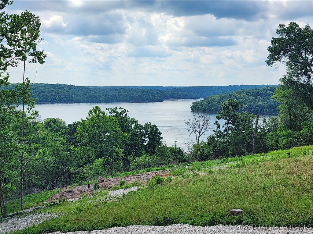 NO BUILDING HEIGHT RESTRICTIONS!!! AMAZING LAKE VIEW! Discover the perfect spot to build your lake retreat on this .24-acre lot located in Kaiser, MO at the 5MM of the Grand Glaize arm of the Lake of the Ozarks. Situated within the Camdenton School District, this property offers both a peaceful setting and convenient access to everything lake living has to offer. The lot includes an 12x30 boat slip at the Park Place on the Lake Condos community dock, making it easy to enjoy days on the water. As part of the subdivision, you’ll also have access to a variety of amenities including a community pool, playground area, and more. Golf carts allowed. Lot 10 also available. The lots have upper and lower road access. Whether you’re ready to build now or looking for a future investment, this lot provides an excellent opportunity to enjoy the Lake of the Ozarks lifestyle. Call today to schedule your showing!  Dreams to Reality!
