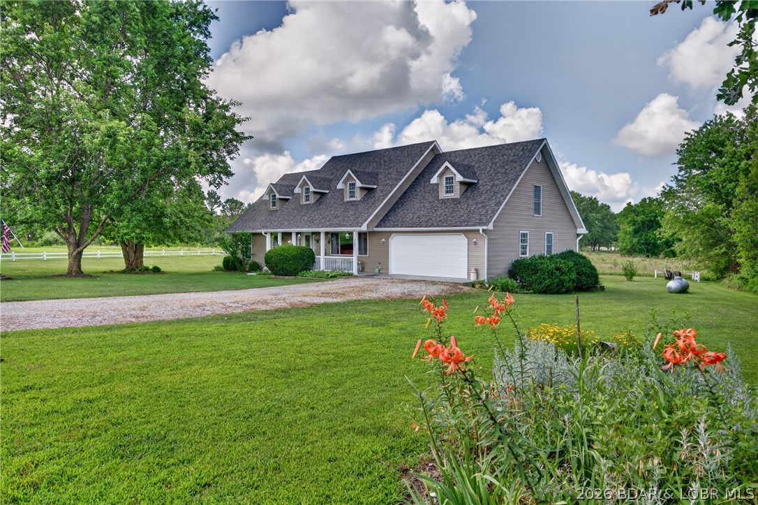 Discover the perfect blend of comfort, craftsmanship, and country living in this beautifully updated 2,660-square-foot home nestled in a quiet neighborhood just outside the city limits. This spacious 3-bedroom, 2.5-bath home is also plumbed for an additional full bathroom, offering room to grow. Inside, you'll find an oversized primary suite, an expansive laundry room, stunning hardwood floors, custom kitchen cabinetry, and an open living area accented by soaring ceilings, roof dormers that flood the home with natural light, and a catwalk overlooking the living room. Recent remodeling, completed in January 2025, enhances the home's modern appeal, while a new roof and gutters provide added peace of mind. Stay comfortable year-round with an efficient wood furnace and propane backup heating system. Step outside onto the large back deck and enjoy peaceful country views, making it the perfect place to relax or entertain. Complete with a two-car garage, this exceptional home offers the privacy of country living with the convenience of nearby amenities.