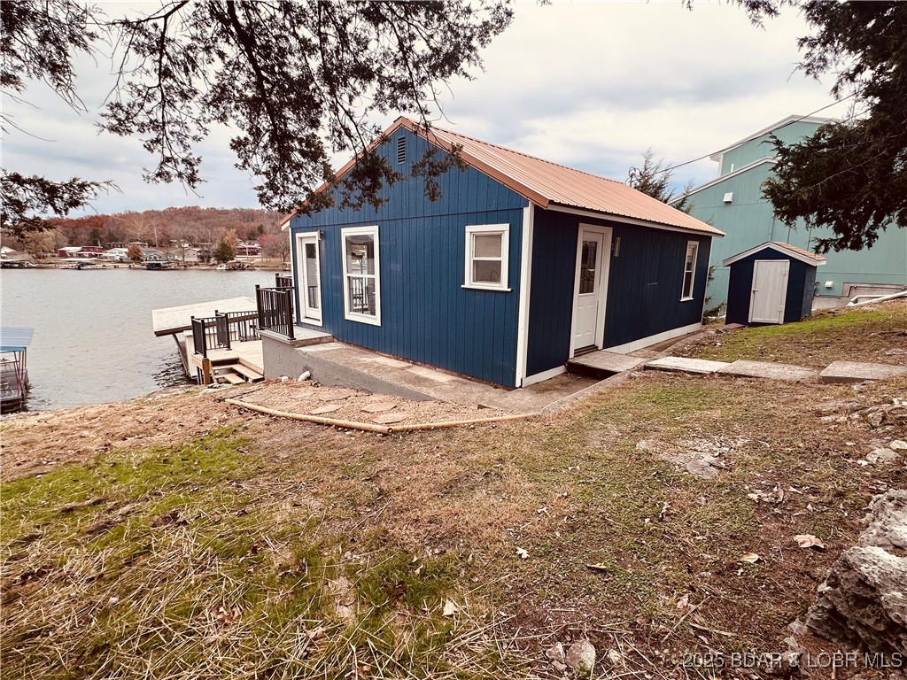 Experience the Ultimate Turnkey Lake Life! Escape to the 66MM for a perfectly renovated retreat located directly across from the popular Bottom Up Marina Bar & Grill. Every detail of this charming 2 bedroom, 1 bath cottage has been meticulously updated, offering a fresh, modern feel with classic lakeside appeal. Upgrades include: Total exterior refresh, new siding, high-end copper metal roof, energy efficient windows, and expansive new decks. Stunning custom Knotty Hickory cabinets paired with premium Cambria Quarts countertops. Situated in a premier fishing cove, you'll enjoy a front row seat to breathtaking views of the main channel and fireworks on the 4th of July. This is more than a cabin, its your ready made lifestyle on the water. Come and see for yourself!