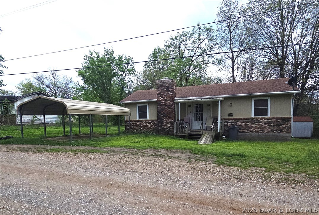 A 2 bedroom, 1 bath home on a double lot in a Lake of the Ozarks community, perfect for weekend or full time living! Mini-split for heat and AC comfort, new roof within the last 5 years, new flooring and hot water heater, fenced back yard, covered porch and deck, 2-storage sheds, fully furnished, clean and ready to move in! Carport up front for parking or room to build a garage on the back lot. COMO fiber internet in the home for your streaming needs and servicing the security cameras in place that will convey with property. Boat ramp to Lake of the Ozarks just minutes away. OWNER FINANCING AVAILABLE.