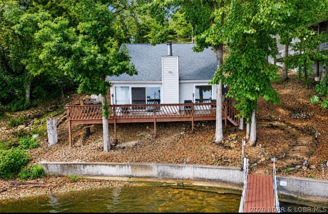 Welcome to your Lake of the Ozarks getaway in the heart of Osage Beach! This 3-bedroom, 2-full-bath lakefront home offers 1,406 sq ft of comfortable living space, beautiful lake views, and the added benefit of cove protection with deep water year-round. Step outside to your 2-well dock, giving you convenient access to boating, fishing, swimming, and everything the lake lifestyle has to offer.

The home comes turnkey and features numerous updates, including a newer roof, appliances, trex brand deck, flooring, fresh paint, and a new septic system installed in June 2024. With ample parking and room to expand, there's plenty of potential to make the property your own.

Whether you're searching for a full-time lake home, weekend retreat, or vacation rental investment, this property checks the boxes. Vacation rentals are allowed, creating an excellent opportunity for rental income when you're not enjoying the home yourself. Conveniently located in Osage Beach near popular restaurants, shopping, entertainment, and lake attractions, this home is ready for its next owners to start making memories at the Lake of the Ozarks!