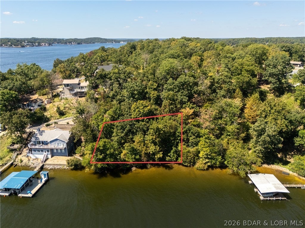 Build your dream home or ultimate lake getaway on this prime waterfront property! Featuring 135 feet of waterfront and 140 feet of road frontage, this east-facing lot offers breathtaking main channel views while being tucked away in a protected, deep water cove. You'll have plenty of shoreline for the perfect custom dock. Plus, the City of Lake Ozark has indicated that public water and sewer are expected to be available for this property by the end of next year (2027). Located just minutes from Lake Ozark and Osage Beach, this property combines quiet cove tranquility with unbeatable convenience to dining, shopping, and entertainment. Don't miss this rare opportunity to create your custom slice of lake life!