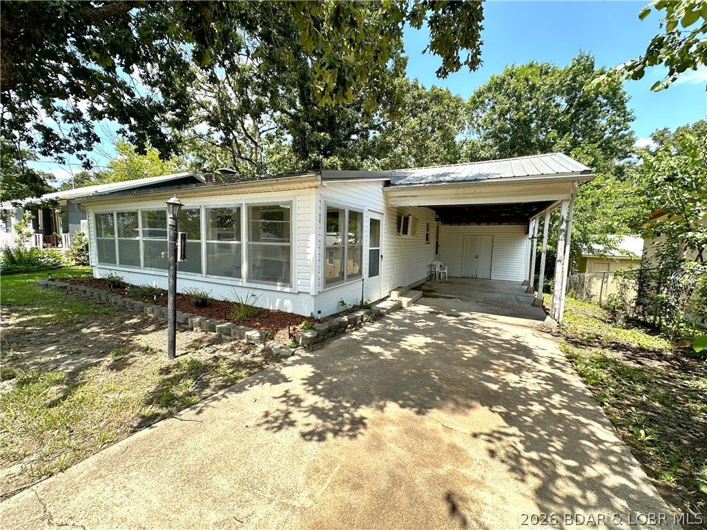 Located at the 86.5MM of the Lake of the Ozarks, this recently remodeled lake cabin features new plumbing, electrical, LVP flooring, enclosed sunroom, a new mini-split, and a wood-burning fireplace. A nice sized driveway gives you plenty of room to park your boat. Just a short 2-minute drive to the Community Boat Docks & Ramp, Shelter House with Playground you'll be ready to host family gatherings and head out on water in no time! Full-time living, weekend getaway, Airbnb, lots of possibilities with this home!