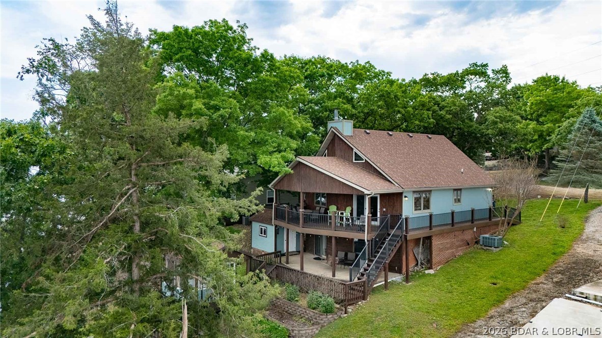 2655 sq ft home checks all of the boxes!  Gentle lot, deep-water cove, great entertainment space, plenty of parking.  You will fall in love the minute you step out of your car.    The main level living area of this home, with cathedral wood ceilings and a beautiful fireplace, is showcased.  Also features a main-level ensuite, a kitchen with multiple cabinets, and a dining area.  Open staircase to the upper-level ensuite, which will sleep multiple guests.  The lower level, completed in 2021, offers a family room, 2 guest bedrooms, a bath with a step-in shower, and a laundry room with ample storage.  Composite decking and walkway add an attractive touch to the outside. Cute as can be, outside building is great for entertaining any time of year. Storage shed with workshop, 2 well dock with swim platform and wet steps, outside storage, all add to a homeowner's dream.