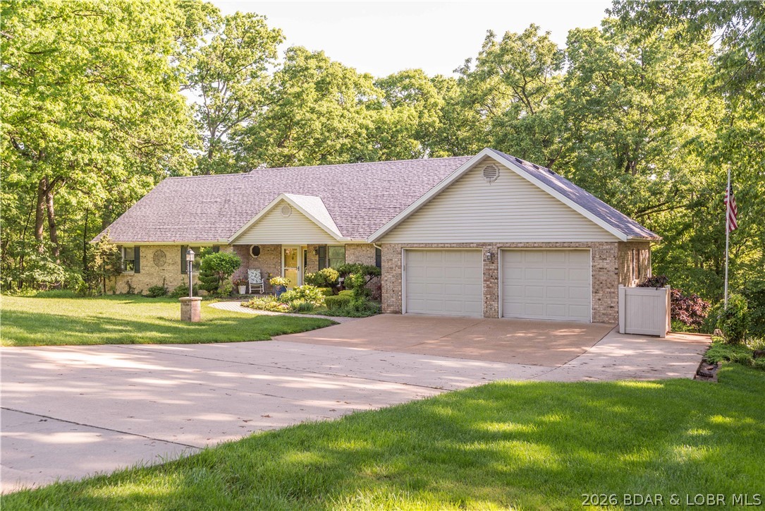 Situated on 2.98 beautifully landscaped acres in the desirable Tall Oaks subdivision, this stunning ranch home offers peaceful country living just minutes from town conveniences. Surrounded by mature trees, wildlife, and bluebird houses, the immaculate property features sunrooms on both levels, spacious patios and decks, wood floors, two gas fireplaces, and an inviting great room filled with natural light. The updated kitchen includes a granite island, warming drawer, abundant cabinetry, and all appliances convey. The main-level primary suite offers a private balcony, dual closets, and a luxurious updated bath with soaking tub and tiled walk-in shower. The finished lower level adds two bedrooms, a full bath, second sunroom, large family room with fireplace, and wet bar for entertaining. Additional highlights include dual driveways, oversized garages, workshop space, geothermal heat pump (2018), water heater (2023), central vacuum, sprinkler system, and more—creating a truly special private retreat inside and out.