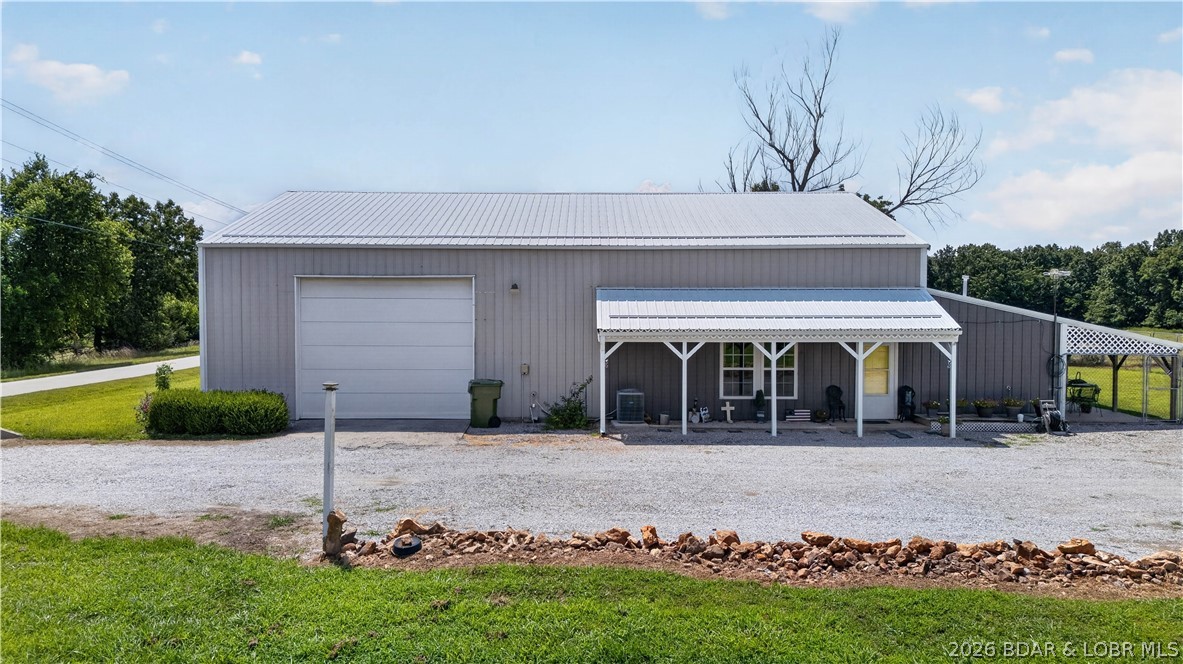 Enjoy the best of country living on this versatile 60± acre farm located on a state-maintained blacktop road just minutes from Truman Lake. The property features a newer oversized 2-bedroom, 1.5-bath shouse with spacious rooms, an open layout, and room for future expansion. A 40'x 30' attached garage/shop with oversized doors and plumbed air lines, along with a 50'x 30' machine shed, provide excellent storage and workspace. The acreage offers a great mix of farming and recreation with opportunities for livestock, hay production, hunting, trail riding, and fishing in the private pond. Whether you're looking for a working farm, weekend getaway, or full-time residence, this property offers endless possibilities in a fantastic location near Truman Lake.