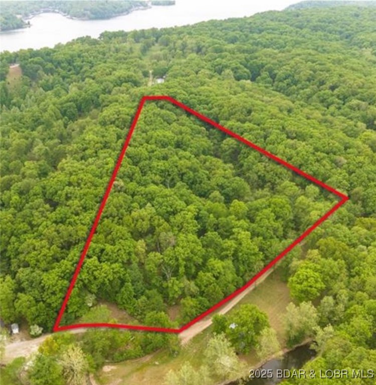 Great Opportunity to build a second tier home with beautiful views of Lake of the Ozarks! This 6.7 acre property leaves room for a beautiful home, workshop, green house, guest house, and still have trails for recreational purposes. Come see if this is the one for you.