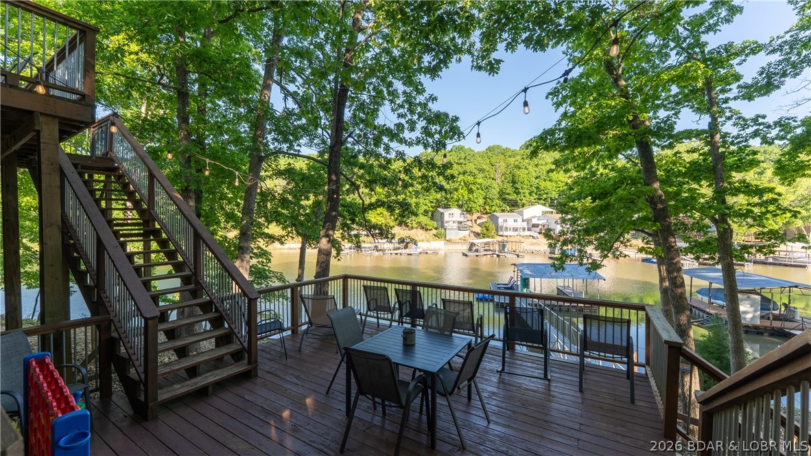 Experience the best of Lake of the Ozarks living with this exceptional property in the heart of Osage Beach! Currently operating as a successful vacation rental, this home also offers everything needed for a fantastic full-time lake retreat. Tucked away at the end of Yacht Club Drive in a peaceful cove, you’ll enjoy a rare blend of privacy while still being just minutes from the dining, shopping, entertainment, and waterfront fun that make this one of the lake’s most desirable locations. The gently sloping lot adds to the property’s appeal with easy access and usability. Inside, the home features two primary suites, including one added in a recent remodel, making the layout ideal for hosting family and guests. Stylish updates include granite countertops, stainless steel appliances, and modern fixtures throughout. Major improvements include a new septic system, HVAC, and water heater for added peace of mind. Properties offering this mix of location, privacy, and versatility are hard to find—schedule your showing and see what makes this one so special.