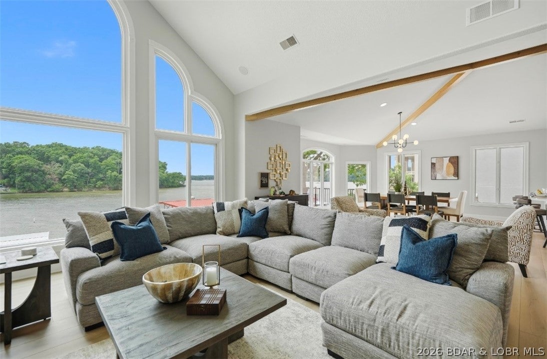 Experience lakefront living at its finest in this beautifully updated and TURN KEY home located in the prestigious Porto Cima area. Perfectly positioned on the 14-mile marker with breathtaking main channel views and protected cove docking, this exceptional property offers over 4,700 square feet of thoughtfully designed living space. The home features 4 bedrooms, 4.5 bathrooms, soaring vaulted ceilings, and walls of windows that showcase panoramic Lake of the Ozarks views from nearly every room. Recent improvements make this property truly move-in ready, including extensive interior updates and a newer dock designed for effortless
lake enjoyment. Host family and friends on the expansive lakeside deck, or spend the day on the water from your private dock. With approximately 87 feet of shoreline, easy access to the water, and stunning sunset views, this home delivers the ultimate Lake of the Ozarks lifestyle.