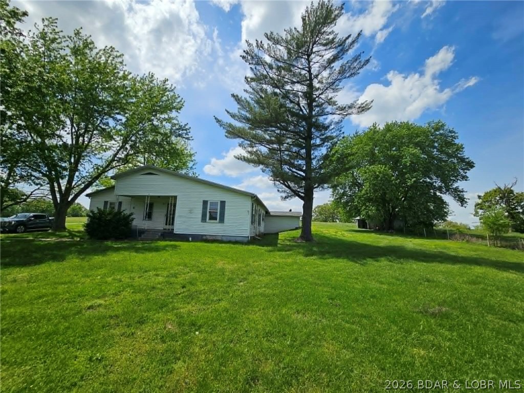 Nestled in a beautiful country setting on a blacktop road, this home offers the perfect blend of peaceful living and convenience — just minutes from Eldon, Lake of the Ozarks, and Jefferson City. Featuring a spacious floor plan, this property is full of potential and ready for your personal touch. With a little sweat equity, you can transform this into the charming country home you’ve always dreamed of. One level living with a storm cellar access from inside the home. The seller is currently in the process of surveying +/- 3 acres to be included with the property. This home has been tenant occupied for a long time and tenant has recently moved out. Outside, you’ll love the large mature shade trees, outbuilding, and ample parking space — giving you plenty of room to spread out and enjoy country living.