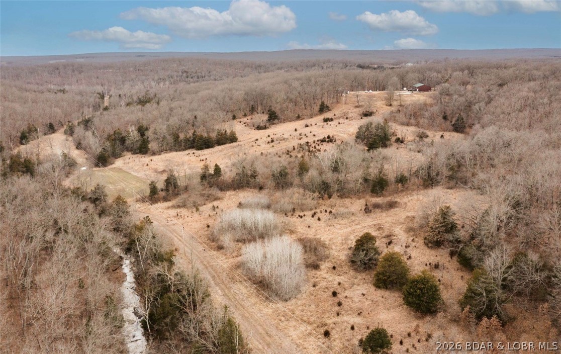 Opportunity to own 40+\- acres of prime recreational and hunting ground in the heart of Morgan County, just outside of Versailles, Missouri. This versatile property offers the perfect combination of privacy, functionality, and future potential.

The property includes a 40x30 (2 bedroom, 1 bathroom) home—ideal as a full-time residence, hunting cabin, or weekend retreat. A 64x40 three-bay shop with concrete floors provides ample space for equipment storage, vehicles, ATVs, boats, or workshop needs.

This acreage is a true outdoorsman’s paradise, featuring abundant wildlife including deer and turkey, making it an exceptional hunting property. The mix of open ground and timber creates excellent habitat and year-round recreational opportunities.

In addition to the existing home, the property offers a prime building site perfectly positioned for someone looking to construct their dream home overlooking nearly 40 +\- acres of breathtaking countryside(additional acreage available)

Whether you’re searching for a private retreat, income-producing recreational ground, hunting property, or a future homesite with acreage, this one checks all the boxes.