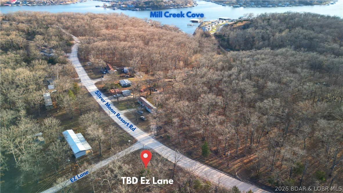 If you’ve been wishing for extra space near the lake for a shop, man cave, or storage building, this is the opportunity that finally makes sense. Located off P Road in Gravois Mills, this flat, usable land parcel sits just off the lake and offers a rare chance to add functional space close to the water. The land is flat and build friendly, making it a great option for a new build, guest house, or secondary structure to complement nearby lake homes. The location is excellent with close proximity to Mermaid Cove Marina & RV Resort, Lake Burger and Mill Creek Cove, making it especially ideal for nearby homeowners or RV owners who need additional storage. This setting keeps you near the lake while still enjoying easy access by road. The property offers road frontage along Silver Moon Resort Rd & EZ Lane Rd, adding flexibility for access and future use. Practical, versatile and increasingly hard to find, this property delivers the kind of convenience that enhances lake life without the lakefront price tag.