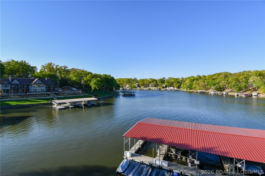 This is the perfect lakefront condo just in time for summer! Oversized 14'x40' boat slip available for extra $. This spacious 3-bedroom, 3 full bath condo in Harbour Bay offers the perfect blend of comfort, convenience, and unbeatable lake views. Located in a quiet, gated community, you’ll love the peaceful setting with easy access to all the action. Start your mornings with coffee on the deck, taking in the beautiful eastern exposure and sweeping views of the cove & Main Channel. Inside, the condo is partially furnished, featuring numerous updates including stainless steel appliances, granite countertops, laminate flooring, kitchen backsplash, crown molding, updated lighting, and fresh paint. Bathrooms have been refreshed w/ newer fixtures, making this a truly low-maintenance retreat. Harbour Bay is known for its well-maintained grounds, cooperative & knowledgeable HOA, clean docks, and inviting waterfront promenade, along with pool & swim dock for endless summer fun. And the location? It doesn’t get better. You’re just minutes from popular waterfront dining, entertainment, shopping, the Bagnell Dam Strip, and nearby state parks—whether by land or water.