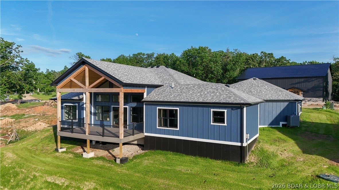 BIG LAKE VIEWS meet thoughtful, zero-step design at this new construction home in Rocky Mount. In Osage school district, this brand-new 2,422 sq. ft. home delivers the space, Amish craftsmanship & accessibility to lake life. 4-bedroom, 2.5-bath floor plan is designed for easy everyday, main level living that makes it an excellent option for aging in place, multi-generational living or those who value high quality construction w/out sacrificing style. At the heart of the home, the custom kitchen features solid wood hickory cabinetry, quartz countertops, black stainless appliances, walk-in pantry & oversized island creating a warm, functional space built for everything from quiet mornings to a house full of guests. Generous living spaces & sweeping lake views through floor to ceiling windows to covered back deck w/ tongue & groove ceiling make water part of your everyday backdrop year round. Two additional adjoining lots are also available for purchase for those looking to expand their workshop space or opportunity to protect your privacy & elbow room. Seller is willing to include a one year lease on boat slip at LOTO Marina that is a quick golf cart or SXS ride up the road.