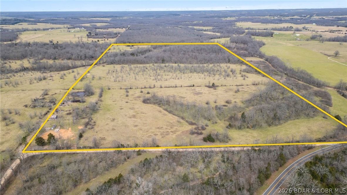 This 255± acre tract represents a well-balanced property with the kind of diversity and usability serious land buyers look for. Less than 0.2 miles of gravel rd from highway access. Dual access from two separate roads allows for excellent ingress, egress, and operational flexibility. The property is comprised of mixed pasture and mature timber, creating a strong setup for mixed agricultural use. Gently rolling terrain supports livestock, hay production, or equestrian use, while the timber provides both habitat and long-term value. Established walnut trees. Water resources- with three ponds, two spring-fed creeks, and two existing wells, along with utilities already on site. The combo of open ground, timber, and water creates excellent wildlife habitat, making this a highly attractive hunting property. Privacy can be tailored to the buyer, all while maintaining easy access via quality country roads. Conveniently located near Interstate 44 and Lake of the Ozarks, this is a versatile, high-quality tract that’s becoming increasingly difficult to find. Schedule a private showing to fully appreciate what this property has to offer. Call for a private showing today!