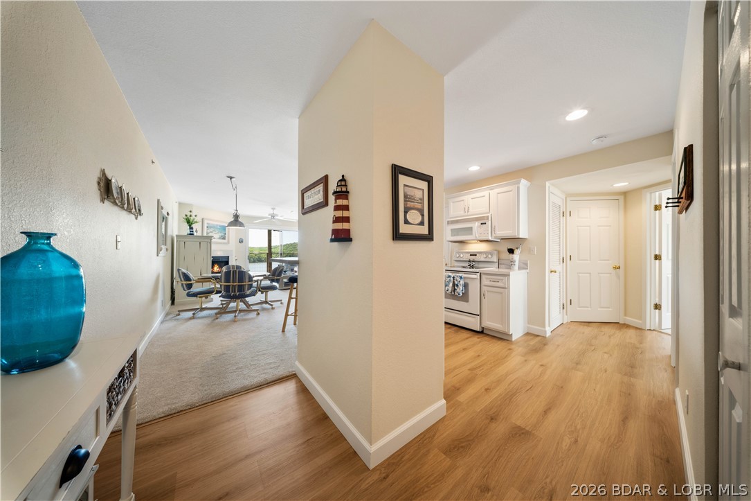 Experience the ultimate lake lifestyle in this stunning 3-br, 2-bath condo at the 5MM of the Grand Glaize Arm at Lake of the Ozarks. Nestled within the State Park, this condo offers an unparalleled blend of tranquility & adventure. Enjoy a updated interior featuring a nautical flair. Step out to morning sunrises & one of the best unobstructed panoramic views in the complex that can be enjoyed from the deck, living room & master br. Being an end unit, extra windows flood the space with natural light, highlighting extensive 2023 renovations-new kitchen & bathroom cabinets/counters, fresh flooring, updated paint, & new hot water heater. 12x30 boat slip included, giving you immediate access to the best boating, fishing, & water sport areas. Only a short boat ride away are iconic spots like Dog Days, Backwater Jacks, Shorty Pants, & Redhead. The complex boasts a community pool, clubhouse w/workout room & convenient on-site trailer parking. The complex is nestled in the State Park where a beach, hiking/biking trails, boat launch & horseback riding are enjoyed. Best of all, you are only 10 miles/15 min from shopping & dining, avoiding traffic hassles. Dreams to Reality!  Call Today!