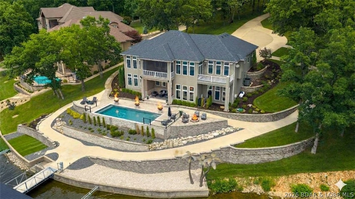 Discover unparalleled luxury in The Villages at Shawnee Bend, the lake's premier luxury home development. Situated in the gated enclave of Forestridge Village on a rare, sprawling estate of nearly 2 acres with almost 300 feet of gentle shoreline, this masterfully updated 4,200 sq ft residence blends sophisticated elegance with premier lake functionality.

Designed for effortless living, the main level boasts a sleek, modern chef’s kitchen with a massive island, a luxurious primary ensuite, and a seamless transition to a private, screened covered deck. The walkout lower level is an entertainer’s dream, hosting a family room, full wet bar, billiards room, and three additional private ensuite bedrooms.

Outside, a private pool steps down to an absolute powerhouse of a dock. Engineered for serious boaters and high-performance watercraft, this massive, 4-well setup sits in exceptionally calm water with striking main channel views, boasting 50’+ slips and 4 PWC spaces.

This secure property features all-underground utilities—essential peace of mind. Exclusive community amenities include pickleball courts, a pool, and premium access to the world-class Harbor 19 Marina.