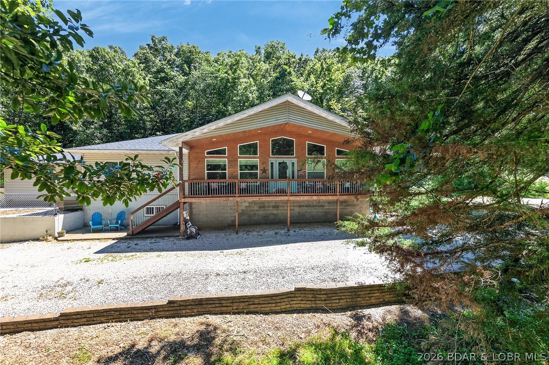 Are you looking for a peaceful setting close to the Lake of the Ozarks? You found it! Beautiful Property with 14+/- acres, 2 pastures (perfect for hobby farm), ATV trails….PLUS two Homes on the Property. Main Home features One Level Living(2795 sq ft), Open Floorplan, Vaulted Ceiling, Stunning Kitchen w/beautiful cabinets and tons of Counter Space, Butcher Block Island, Stainless Appliances, Pantry, Oversized Primary Suite w/2 walk in closets, Soaking tub & walk in tiled shower, covered patio off primary suite w/hot tub, 2 guest bedrooms on main level (1 is ensuite), Unfinished basement (can be used as 4th bedroom), Covered front deck- perfect for enjoying the view, Large Patio off of the HUGE Dining room and 2 car attached Garage. Guest Home features- 800 sq ft, 2 bedrooms, 1 bath, Covered Deck, Open Living Room/Kitchen Area, 2 car carport and it comes Furnished! There is also a 30x40 Garage, Barn, outbuilding (perfect for parking your toys), fenced in Garden Area and a Swimming Pool w/Large Deck w/bar (so fun)! Definitely a Park Like Setting. New Roof on Main Home, Guest Home & Well House Fall of 2023. Located a few miles from the State Park = Boating, swimming, hiking & More!!!