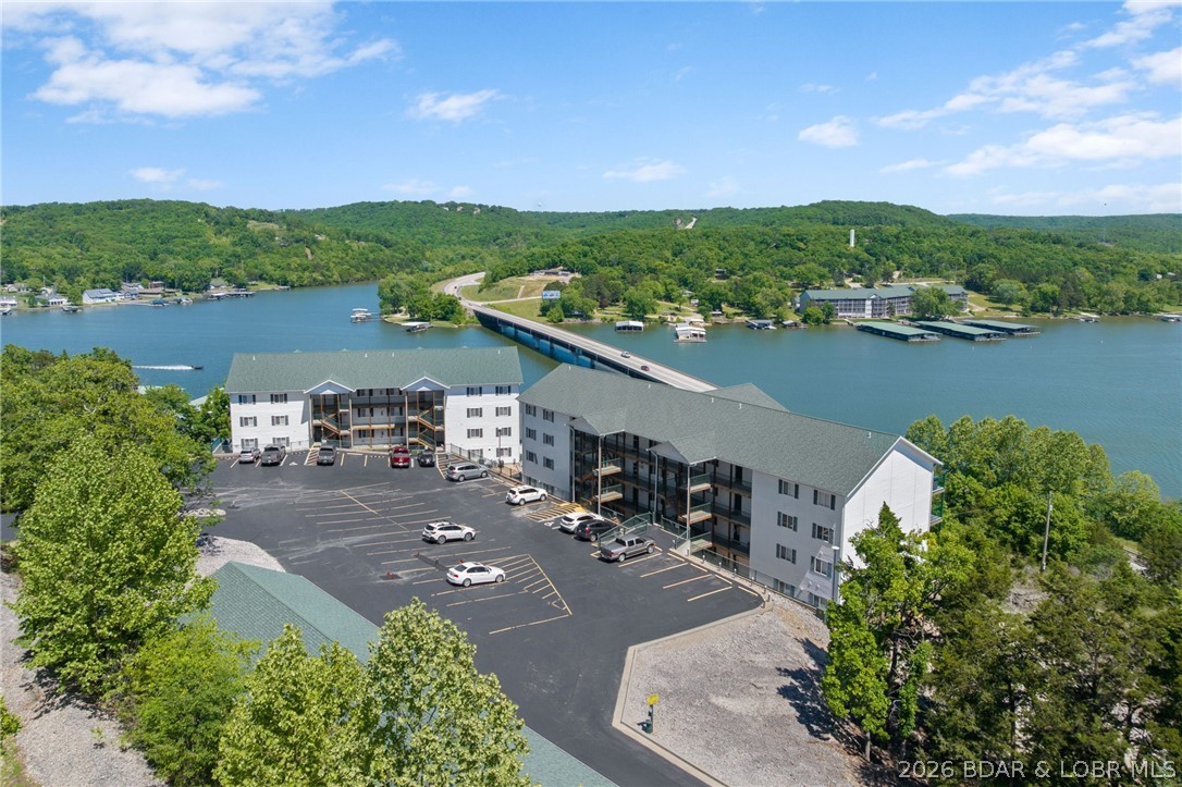 MOTIVATED SELLERS!!! Experience lakefront living at its finest in this beautifully updated 3-bedroom, 2-bath condo overlooking the breathtaking Big Niangua at the 13-mile marker. Well maintained community with 3 pools!!! Perched perfectly for million-dollar views and direct lake access, this lower-level, fully handicap-accessible unit offers comfort, convenience, and style. Enjoy luxury vinyl plank flooring, tile finishes, and a spacious walk-in shower complete with grab bars. The open-concept layout flows seamlessly to outdoor living where you can take in panoramic water views. Included is a coveted 10x24 boat slip in the community dock, for fishing and boating.  A garage is available for extra $, perfect to store a golf cart or your lake toys. Handicap parking is conveniently located nearby, making access effortless. Whether you're looking for a full-time residence or the perfect lake getaway, this condo combines accessibility, luxury, and unbeatable lakefront living.