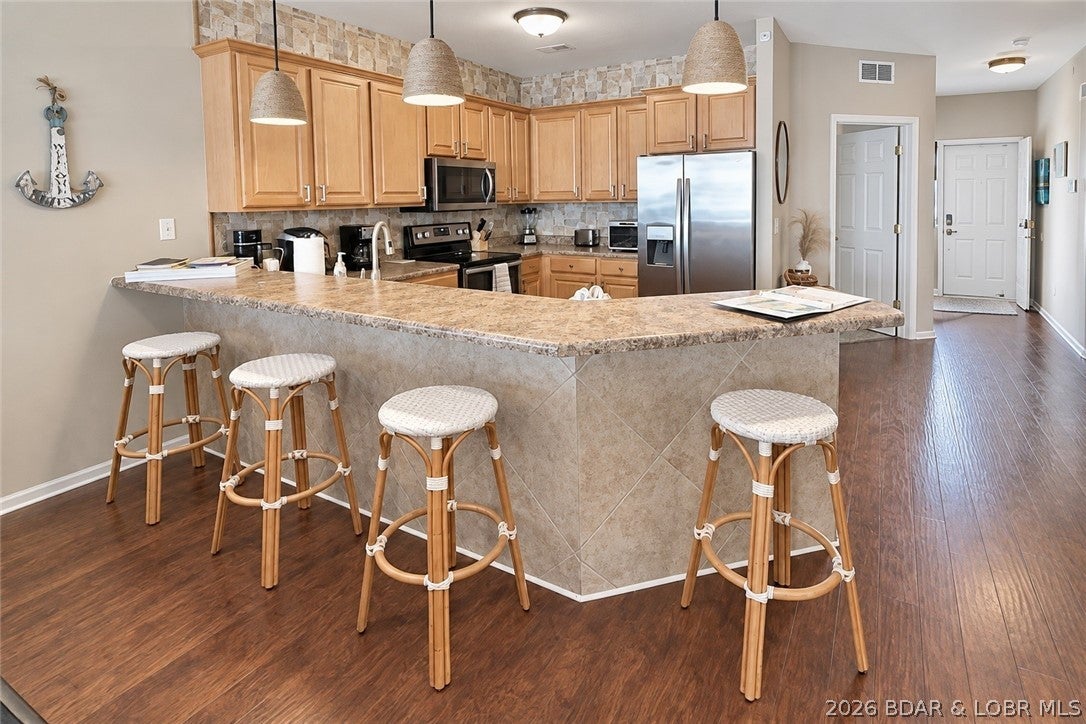 TOP FLOOR - BEST VIEW - REMODELED - AND the kicker... nearly 300 AWESOME reviews (9.8 Star Rating) will transfer to the new owner.  LONG TERM VRBO RENTAL HISTORY is available to transfer to the new owner if you're looking to skip the hard part of growing a successful vacation rental.  We have personally loved this unit so much but it's time to move on.  TURN KEY.  Successful track record and proven vacation rental at the area's premier condo property - super close to the brand new Oasis Theme Park.  Best of the best area - close to shopping, 5 star dining, groceries, and much more!  TOP FLOOR BEST VIEW so don't worry about hearing that noisy neighbor above.  Huge boat slip?  You've got it!  BREATHTAKING main channel views, resort-style amenities, and one of the most desirable locations on the lake @ the 18 MM.  Resort style heated zero-entry pool with stellar lake view, the lazy river and kiddie pool, clubhouse w/ a gym, future development spot TBD!!  So much fun awaits you at this Lands End Property.  MAXIMALLY furnished & stocked - solid wood flooring, high-end gallery appliances, screened in porch.... sunsets and main channel views!
