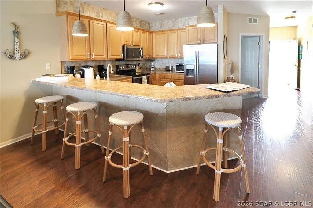 TOP FLOOR - BEST VIEW - REMODELED - AND the kicker... nearly 300 AWESOME reviews (9.8 Star Rating) will transfer to the new owner.  LONG TERM VRBO RENTAL HISTORY is available to transfer to the new owner if you're looking to skip the hard part of growing a successful vacation rental.  We have personally loved this unit so much but it's time to move on.  TURN KEY.  Successful track record and proven vacation rental at the area's premier condo property - super close to the brand new Oasis Theme Park.  Best of the best area - close to shopping, 5 star dining, groceries, and much more!  TOP FLOOR BEST VIEW so don't worry about hearing that noisy neighbor above.  Huge boat slip?  You've got it!  BREATHTAKING main channel views, resort-style amenities, and one of the most desirable locations on the lake @ the 18 MM.  Resort style heated zero-entry pool with stellar lake view, the lazy river and kiddie pool, clubhouse w/ a gym, future development spot TBD!!  So much fun awaits you at this Lands End Property.  MAXIMALLY furnished & stocked - solid wood flooring, high-end gallery appliances, screened in porch.... sunsets and main channel views!