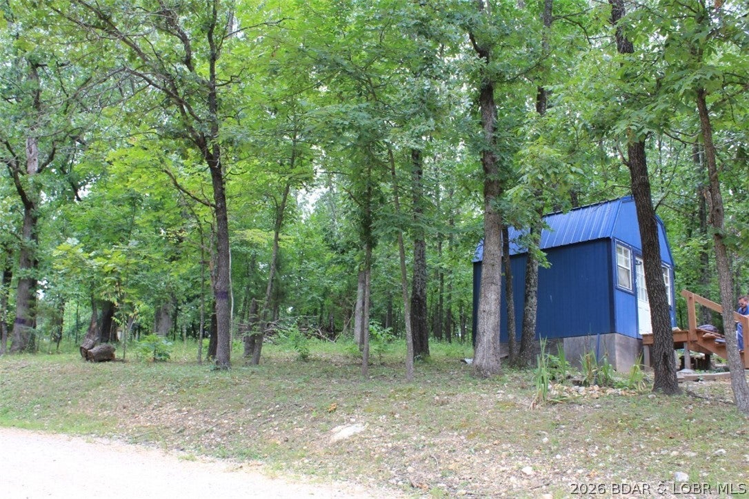 Looking for your own little slice of the Ozarks? This nearly 1-acre property in Macks Creek offers an affordable opportunity to create your own weekend getaway, recreational retreat, or off-grid escape!
Already on the property is a shed-style tiny cabin equipped with two solar panels that provide electricity, giving you a great head start on your Lake-area retreat. Bring your ideas and make it your own!
Outdoor enthusiasts will appreciate being approximately 24 minutes from Blackberry Ridge Sporting Clays at the Missouri Trap Shooters Association, plus you’re just minutes from all the recreation, dining, boating, fishing and entertainment the Lake of the Ozarks has to offer.
IMPORTANT: Property currently has NO well or running water and NO septic system. Electricity is supplied by the two existing solar panels.