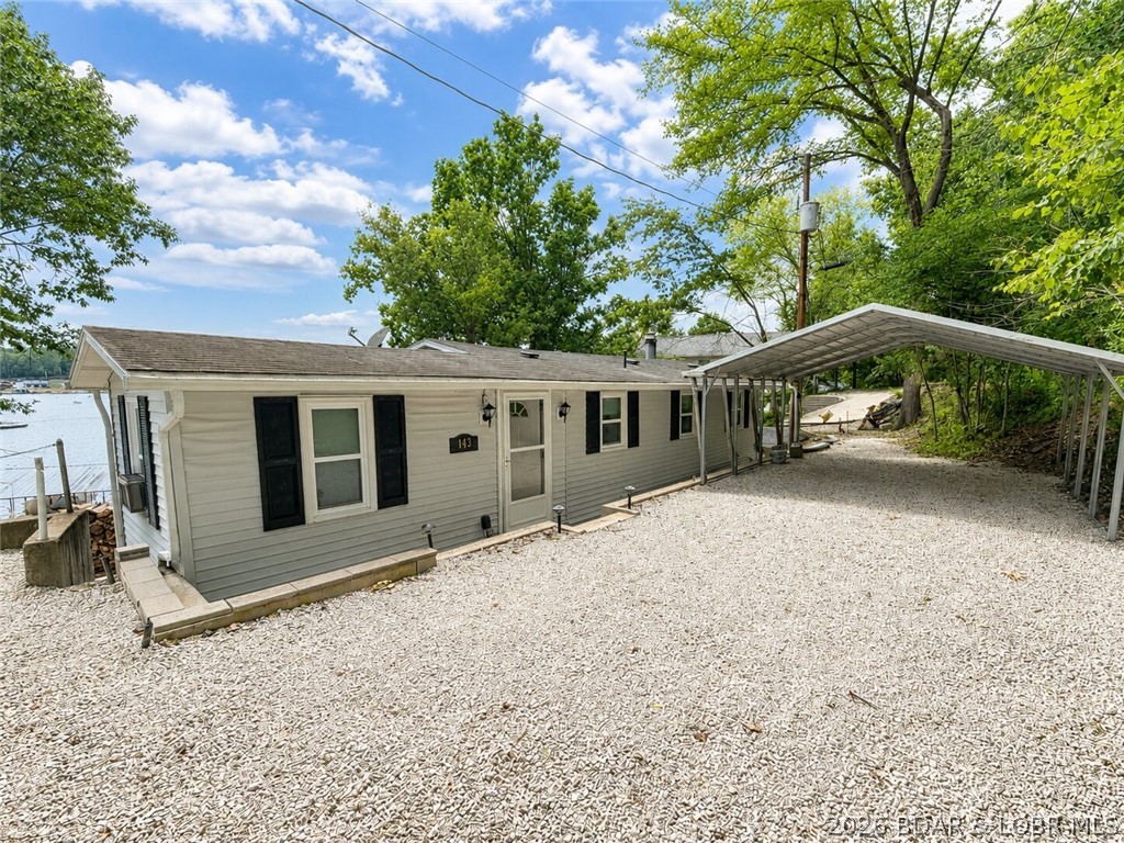 Affordable lakefront opportunities under $300K are becoming harder to find, and this is your chance to get into one of the Lake's most popular waterfront neighborhoods! Located in the calm, clear waters of the Little Niangua Arm, 143 Breezy Point offers 70 feet of lakefront in an area known for excellent boating, swimming, and fishing.  The home features 2 bedrooms and 1 bath, with the lower level already plumbed for an additional bathroom and ready to be finished into extra bedrooms, a family room, game room, or whatever fits your vision. A second-tier lot is included, providing valuable space for overflow parking or the perfect spot to build a garage or workshop. Enjoy easy access to the water, a lakeside storage shed for all your fishing and swimming gear, plus an additional storage building with an overhead door.   Whether you're looking for a weekend retreat, rental investment, or full-time lake home, this property offers lots of upside and the opportunity to build instant equity. Plus, a brand new deck just installed!  Lake living has never been more attainable.  Check it out TODAY!!
