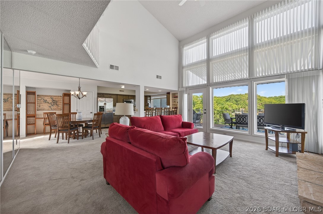 This is it—everything you've been looking for! Open-Floor Plan, Furnished, Garage, 2 Boat Slips with Lifts/Hoists (including one with a Captain's Call remote system), 3 sleeping rooms (2 bedrooms & spacious Loft), and 2 full baths. This truly turnkey lakefront condo at Shores of Camelot in Libby Cove offers stunning lake views at the 2MM of the Niangua Arm. The open floor plan showcased by a wall of windows offers abundant natural light, a cozy fireplace, stainless steel appliances, and additional bar seating. The main level includes a bedroom, full bath, and laundry area. Upstairs offers a second bedroom with private balcony access, another full bath, and a loft-style third sleeping area for additional guests. Relax on the private deck with a retractable awning while enjoying beautiful lake views. Additional features include a garage, 5x10 storage closet, and two boat slips with lifts. Community amenities include a swimming pool. Clean, well cared for, fully furnished, and ready for immediate lake enjoyment!