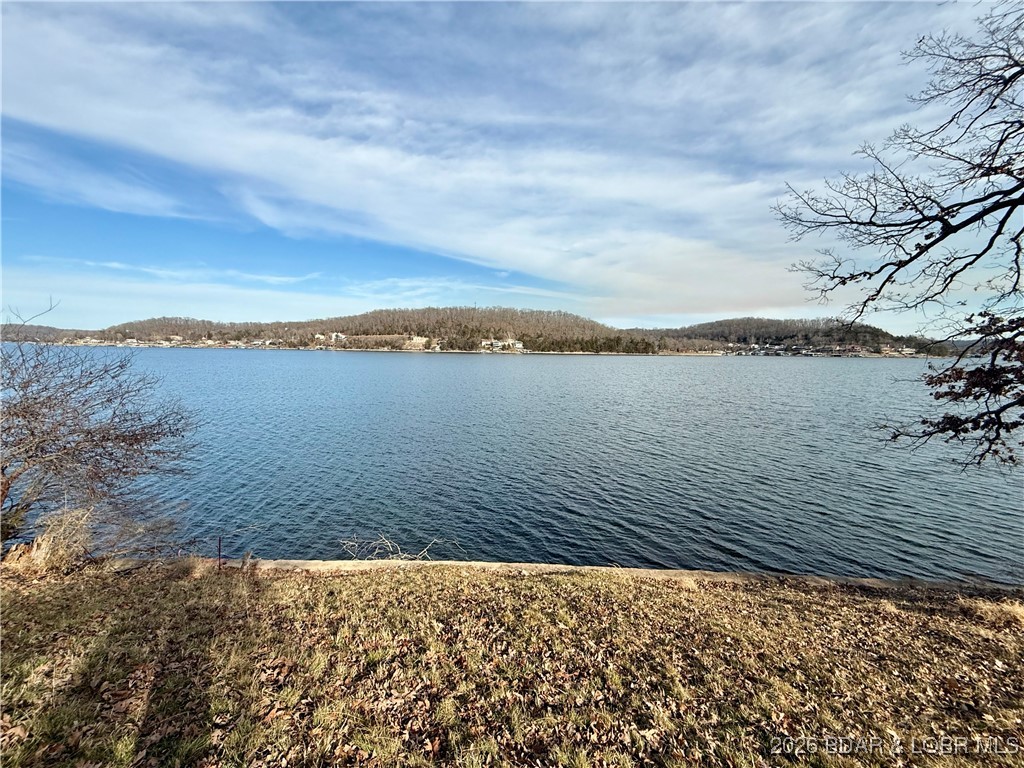 Gravois Arm Lakefront Lot with Seawall, Utilities, Bonus Parking & Room to Dream. Lakefront lots with a seawall and utilities already in place don’t come around often, especially in the Gravois Arm. This gently sloped property offers seawall, water, and an existing septic system installed, plus extra parking spaces surrounding the cul-de-sac for guests and weekends at the lake. Blacktop access makes year-round use easy, and you’re minutes from the Lake of the Ozarks top destinations. A portion of the lot includes the septic treatment area ideal for a buyer with vision and smart site planning. Seller will consider all reasonable offers.
