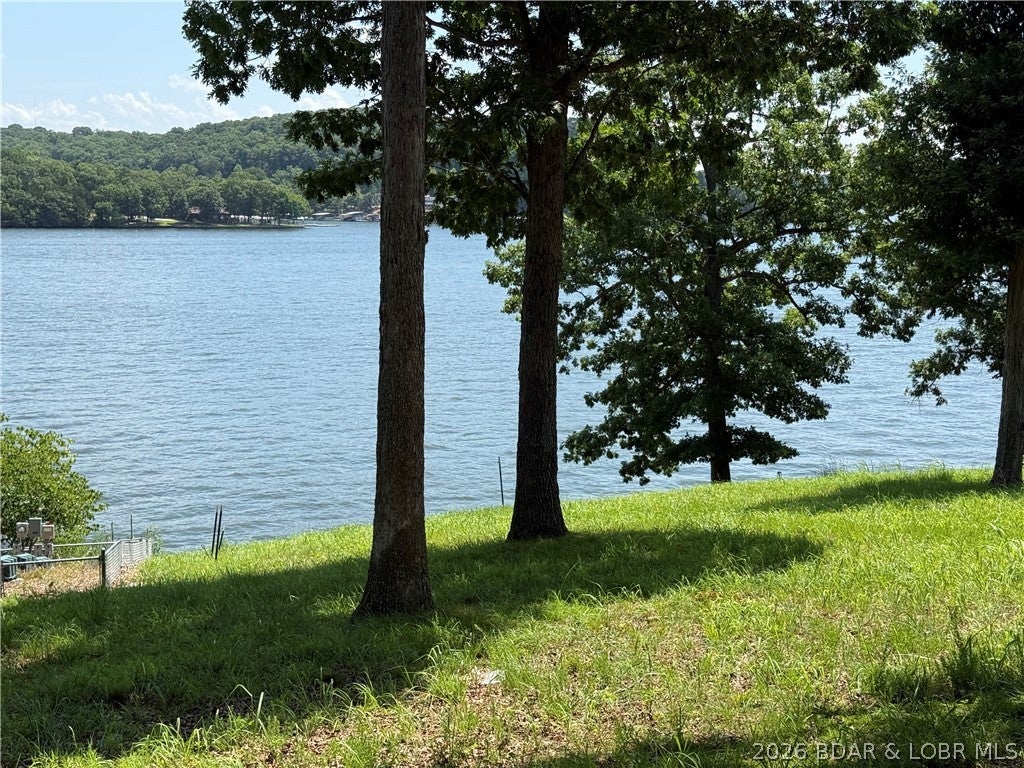 Gravois Arm Lakefront Lot with Seawall, Utilities, Bonus Parking & Room to Dream. Lakefront lots with a seawall and utilities already in place don’t come around often, especially in the Gravois Arm. This gently sloped property offers seawall, water, and an existing septic system installed, plus extra parking spaces surrounding the cul-de-sac for guests and weekends at the lake. Blacktop access makes year-round use easy, and you’re minutes from the Lake of the Ozarks top destinations. A portion of the lot includes the septic treatment area ideal for a buyer with vision and smart site planning. Seller will consider all reasonable offers.