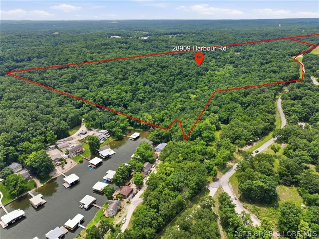 An exceptional opportunity to acquire approximately 196 acres of development-ready land in Gravois Mills, Missouri, within the Lake of the Ozarks region. Originally planned as part of the master-planned community known as The Villas of Harbour Hills, this property offers a unique chance for a developer, builder, or investment group to continue the vision—or create an entirely new one.
Significant infrastructure investments have already been made, including both wet and dry utilities extended to the development, providing a substantial head start for future planning and construction. The Water Tower and Well have been rated to service up to 350 homes.  The property's rolling terrain, natural beauty, and strategic location make it suitable for residential, mixed-use, recreational, or resort-style development concepts.  There is lake access in the back of a cove.  Situated near Lake of the Ozarks amenities, marinas, golf courses, dining, and outdoor recreation, the site offers the scale and flexibility required for a transformative project in one of Missouri's most desirable destination markets.