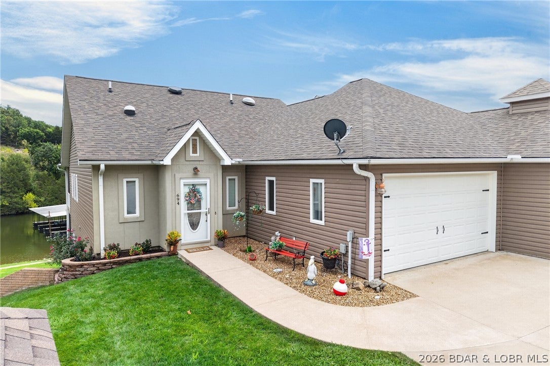 LAKEFRONT LIVING WITH ROOM TO RELAX, ENTERTAIN & ENJOY! This exceptional 3-bedroom, 3.5-bath lakefront townhome offers 2,400+ square feet of updated living space, stunning lake views, & desirable amenities. Enjoy newer LVP flooring, custom kitchen cabinetry, & granite countertops throughout the kitchen and bathrooms. The spacious main-level master suite features his-and-her closets, split vanities, a walk-in shower, & a jetted tub. The main level also includes a living area with a fireplace and screened-in porch overlooking the lake. The walkout lower level adds two bedrooms, two full baths—including a private en suite—plus a kitchenette, abundant storage, & a second screened-in deck. This flexible layout offers plenty of space for family, guests, entertaining, or relaxing. A 2-car garage provides room for vehicles and lake toys, also included is a 12’ x 30’ boat slip with a 6,500-lb hoist. Major updates include a new roof installed in April 2025 & an updated HVAC system in 2024. Whether a full-time residence, weekend getaway, or lake retreat, this home offers beautiful finishes, generous space, incredible views, & convenient water access. Just bring your boat and enjoy lake life!