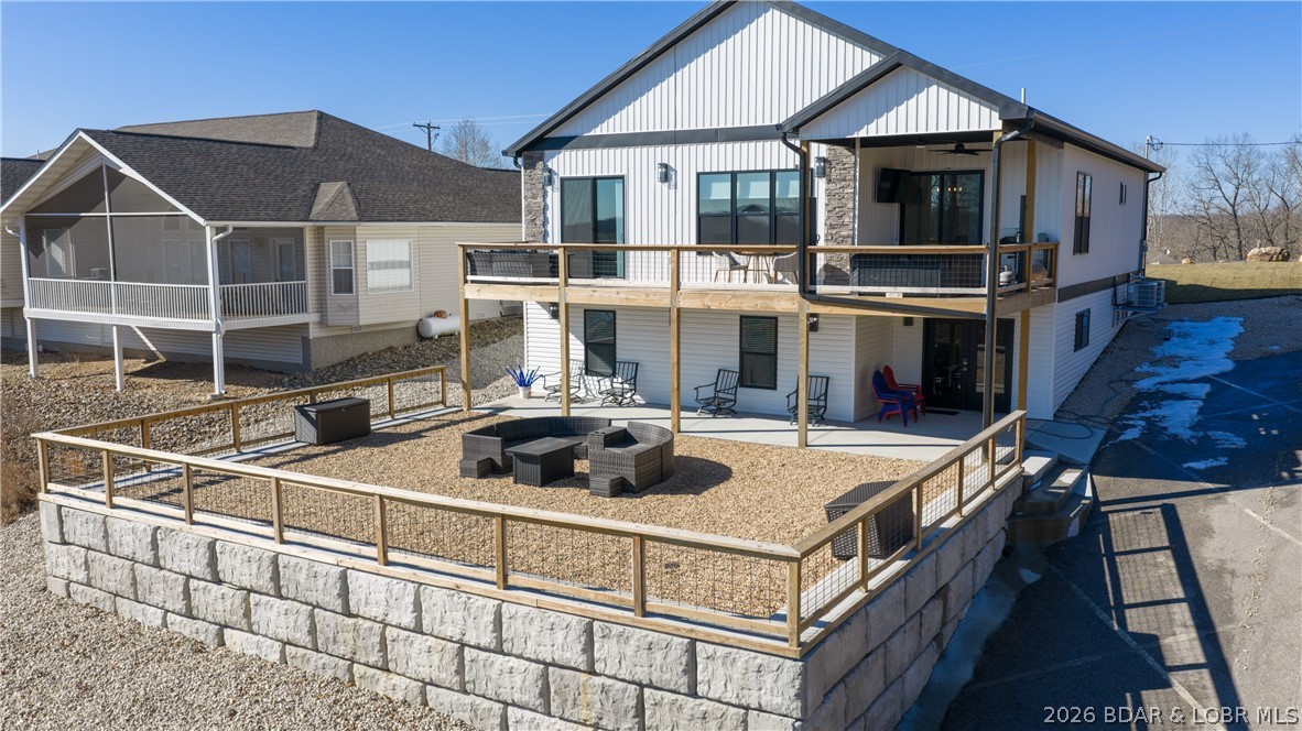 Investment potential meets lake living in this newly constructed lake-view retreat featuring two fully independent living spaces designed for maximum flexibility. With separate entrances, full kitchens, laundry, and private living areas on each level, the home is ideal for short-term rentals, long-term tenants, multi-generational living, or owner-occupants seeking supplemental income. The main level features an open-concept design with granite countertops, luxury finishes, remote blinds, LVP flooring, marble tile baths, and a spacious primary suite with deck access and lake views. The lower level includes 2 bedrooms, 1 bath, a second kitchen, living area, laundry, and private exterior access with side parking for added convenience. Located within the state park and including a 12x30 boat slip, this versatile property creates opportunities to rent one level while enjoying the other, maximize income by utilizing both spaces, or accommodate extended family and guests with privacy for everyone. Whether you're looking for a vacation rental, investment property, or personal lake retreat that can help offset ownership costs, this unique offering delivers flexibility that's hard.