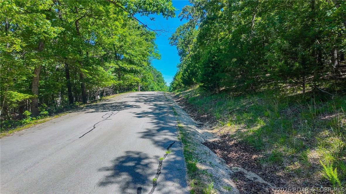 Build your dream home on Muirfield Drive! Discover the perfect canvas for your custom home on this beautiful, level 0.53-acre wooded lot. Offering an ideal blend of natural privacy and premium resort-style living, owners here gain access to incredible Four Seasons amenities, including multiple community pools, a fully equipped exercise room, playgrounds, and more. Building is a breeze with water and sewer agreements already firmly in place; best of all, the utility lines run directly on the same side of the road as the lot. Located in a well-maintained neighborhood with an HOA ensuring community standards, the minimum build requirement is a comfortable 1,100 square feet (or consistent with surrounding homes), perfectly protecting your long-term property value.