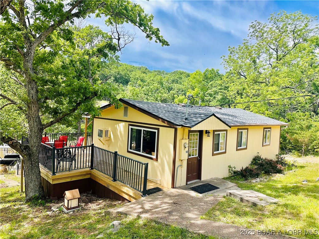 Great VRBO investment!! Just added to the property  is a One Bedroom, One bathroom, Kitchen and living space Camper for extra guest rooms. Located at 52 Random Road, Edwards, Mo., this Lakefront property offers a turn-key investment opportunity. It is ideally situated in a protected cove at the 66 MM, providing access to a variety of water activities. This property boasts 163 feet of lakefront AND includes a 2 bedroom, one bathroom home, perfectly suited for vacation rentals. The inclusion of a sleeper sofa allows the property to accommodate up to six people, potentially attracting a larger renter base. Recent upgrades enhance its appeal:  A NEW Roof, Newly constructed deck and covered deck area. NEW engineered septic system. Guests can enjoy a concrete patio by the lake for grilling after a day of fishing and boating. The Lake of the Ozarks is a strong vacation rental market with high demand from tourists seeking outdoor recreation. Schedule your appt through Showing Time.