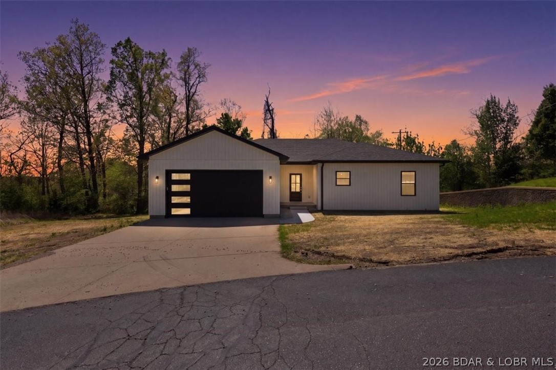 Discover the epitome of modern living in this brand-new construction home, ideally nestled within the sought-after Oak Hill Forest Subdivision and the highly desirable School of the Osage District. This three-bedroom, two-bathroom home offers a seamless, one-level open floor plan, perfect for both everyday living and entertaining, highlighted by a large, inviting kitchen complete with a pantry. Retreat to the luxurious primary suite, featuring a spacious bathroom and an expansive walk-in closet designed for ultimate organization, while practical amenities include a convenient two-car garage and a serene covered back deck. Perfectly situated between Eldon and Lake Ozark, you'll be just minutes from the Bagnell Dam Strip for the lake's best shopping, dining, and fun. Embrace a life of comfort and ease in this wonderful new home, offering the best of country living and lake adventures in a truly premier location.