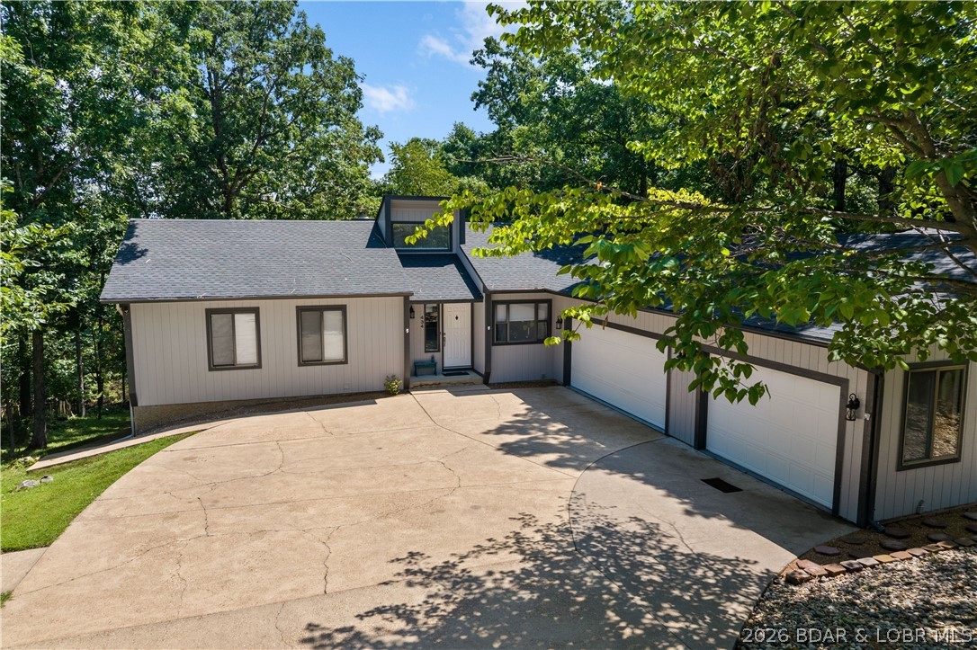 Village of Four Seasons Ranch! Motivated Sellers, Bring Any Reasonable Offer! This Ranch style walk-out home spans 5+ beds & 3 baths, offering a rare layout designed for large families, multi-generational living, & dual-family ownership. The interior has new tile entry, carpet, LED fixtures, ceiling fans, doors. The kitchen consists of quartz countertops, tile backsplash, & new appliances. Primary suite w/ private bath & new quartz vanity. Convenience is key with dedicated main-level laundry. Versatile Lower Level & ADU Potential as the walk-out lower level serves as true 2nd living quarters, w/ wood-plank laminate flooring, living room w/ gas fireplace, full kitchen, 2 BR, bonus room, & a 2nd laundry. Key features: 3-car heated garage + parking for 9; Safe room (plumbed); 9 total appliances: 2 Refrigerators, 2 Dishwashers, 2 Stoves, 1 Washer, 1 Dryer; 1 Microwave; Water Softener-Owned; new water heater; 2-year-old roof, gutters, & fresh paint/trim. Close to amenities including, campground, skate park, swimming pool, tennis courts, playground, boat ramps, fishing lakes & even a new aquatic center for year-round swimming, walking path. Don't miss this one-of-a-kind, turn-key gem!