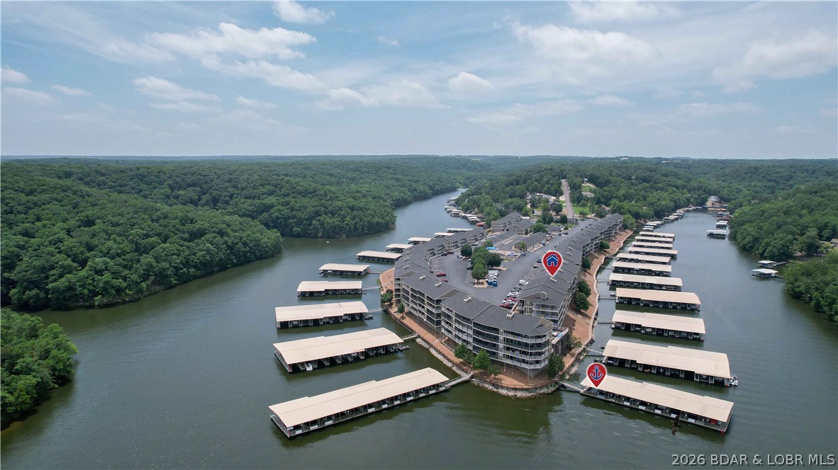 This top-floor Lazy Days condo shows like brand new and is being offered turnkey! This one-owner unit has never been on a rental program and has been meticulously maintained, offering a clean, updated, and move-in-ready lake retreat. Recently remodeled with new countertops, fresh paint, and new LVP flooring and carpet throughout, this condo offers a modern, refreshed feel with quality finishes throughout. The vaulted ceilings create an open and spacious feel in the living area, while the large, well-designed kitchen provides plenty of room for entertaining family and friends. Enjoy lake views and outdoor living from the screened-in deck, the perfect spot for morning coffee or relaxing evenings. This unit includes a 10 x 24 boat slip for your lake toys, and a garage is available for additional purchase for added storage and convenience. Fully furnished and truly turnkey—just bring your clothes and start enjoying lake life today! This beautifully updated Lazy Days condo is ready for immediate enjoyment and the perfect opportunity to own your own piece of the Lake of the Ozarks lifestyle.