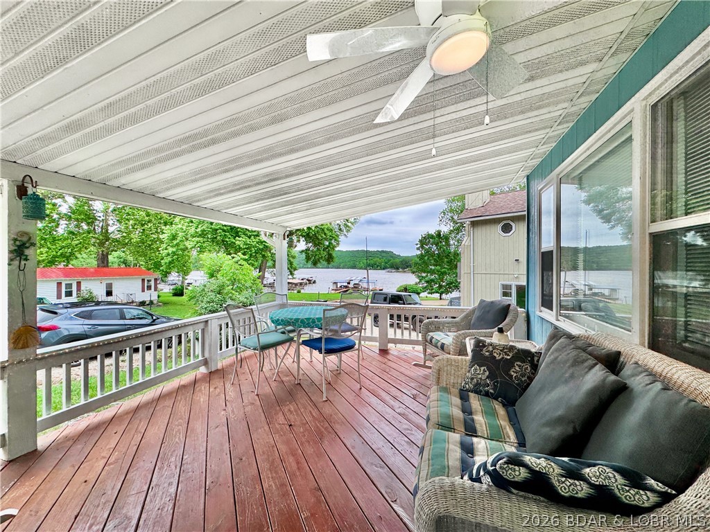 Curated, turnkey, and designed for the ultimate Lake of the Ozarks lifestyle, this beautifully renovated lakeview cabin with dock slip and included lift offers the rare combination of style, flexibility, and income potential. Ideally located on the quiet part of the lake across the channel from iconic Ha Ha Tonka State Park, this furnished property places you minutes from boating, hiking, waterfront dining, 2 golf courses, and everything locals love about the Lake. Thoughtfully updated with a fresh designer-inspired color palette, the property features a renovated kitchen, updated bathrooms, and warm, inviting finishes throughout. The main cottage includes 2 bedrooms and 1 bath, while the finished apartment adjacent to the detached garage adds a private 1 bedroom/1 bath guest suite — ideal for guests, multi-family use, owner’s quarters, or short-term rental potential. Enjoy mornings on the covered front porch and afternoons on the water with the dock slip just a short walk away, complete with the included lift. Offered fully furnished in a short-term rental friendly area, this move-in-ready property is perfectly suited as a vacation home, investment, or personal Lake retreat.