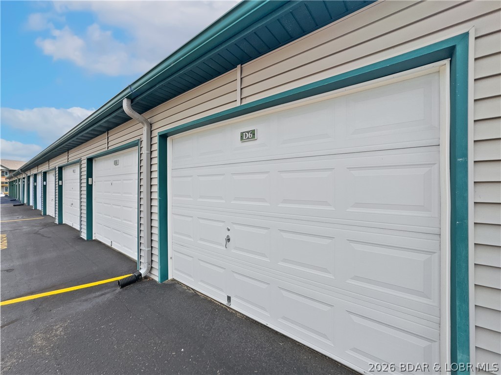 THIS ONE HAS IT ALL!  This well-appointed lakefront unit is a rare find since it comes complete with a 30 ft slip and a GARAGE!  If you are ready to start enjoying lake life, come take a look at this 2 bedroom 2 bath easy access unit. This unit is conveniently located near two top golf courses, a popular winery, restaurants, and Ha Ha Tonka State Park.  This popular complex boasts two heated pools, a playground for children, sand volleyball court, boat trailer parking, and abundant green space as well as a sense of community.  Fully furnished, this condo is ready and waiting for you. This unit can provide you a cozy retreat or even a permanent residence.  Step inside and let your cares slip away. This inviting unit is cozy and comfortable. You will enjoy preparing meals for family and friends in the bright cheery kitchen.  Relax with your morning coffee on This lakeside deck.  This unit offers a 12x30 foot slip with a 10,000# Fibersteel lift. A second slip is available for additional for $28,000 and a PWC is avaiable for $9500.  Don't miss out on an opportunity to have not only a 30 foot slip and also a garage.  Call for a showing today.